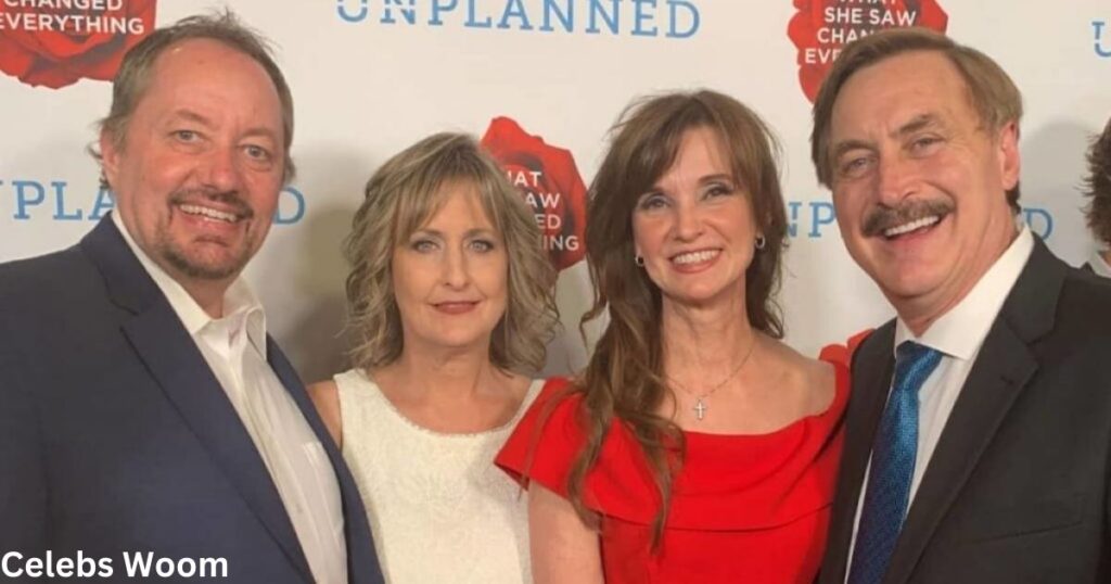 Four people posing in front of an 'Unplanned' movie backdrop.