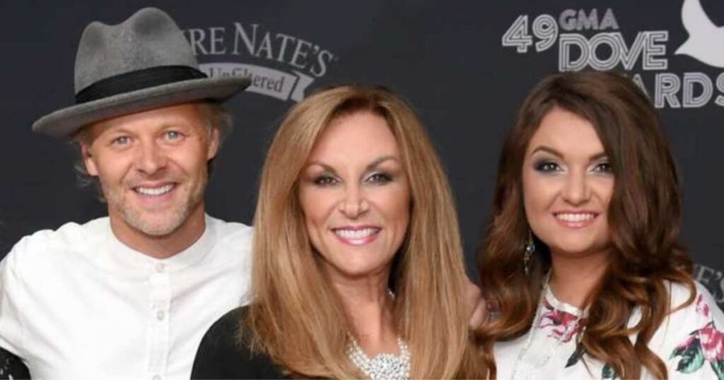 Three people in formal attire at the Dove Awards event.